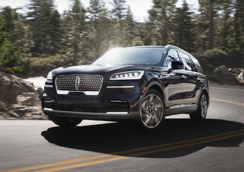 A Lincoln Aviator® SUV is being driven on a winding mountain road | Jenkins & Wynne Lincoln in Clarksville TN