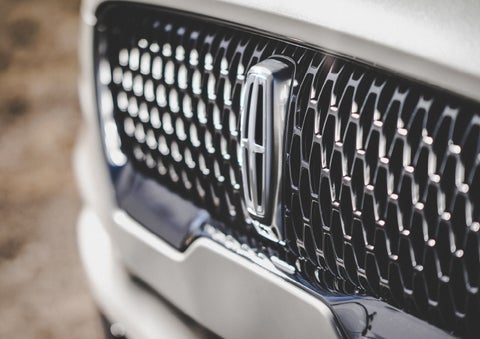 The grille of the 2024 Lincoln Aviator® Reserve model with an eye-catching repeated field of Lincoln Star logo shapes | Jenkins & Wynne Lincoln in Clarksville TN
